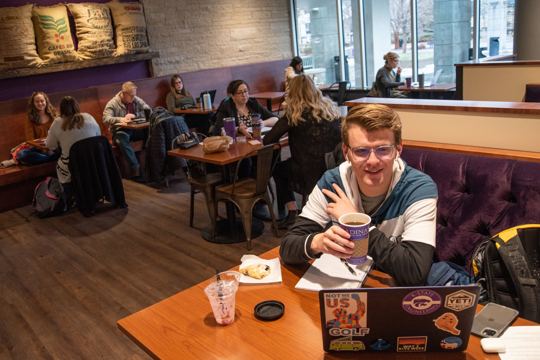 Will Erickson, a K-State sophomore studying Chemical Engineering, does homework at Radina's Coffeehouse & Roastery in the K-State Student Union. ÒItÕs bitter sweet being back. ItÕs nice to see friends but I know my classes will be tougher this semester,Ó said Erickson.